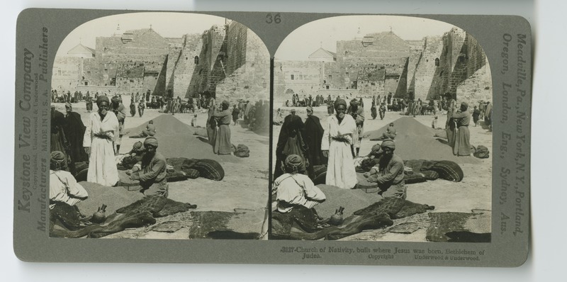 A view of the Church of the Nativity, built on the site of Jesus&#039; birth, with grain vendors selling their wares.