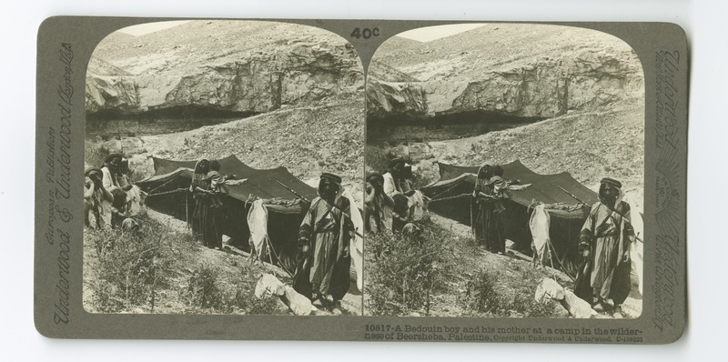 A family of Bedouin nomads standing before their tent which has bee pitched in a ravine between Hebron and the Dead Sea.