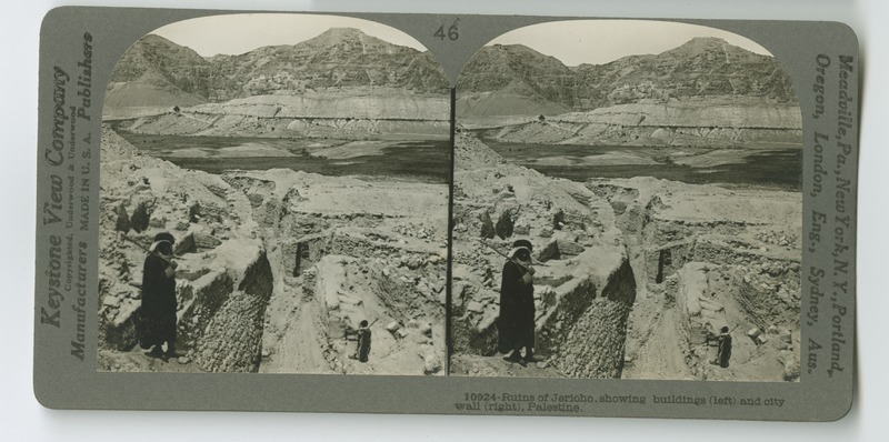 A view of the ruins of ancient Jericho showing some of the buildings and a section of the city wall.