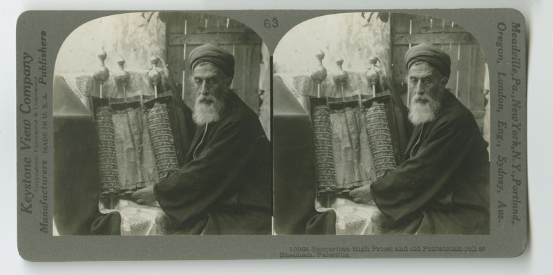 A Samaritan rabbi showing a traditional Torah scroll in its case.
