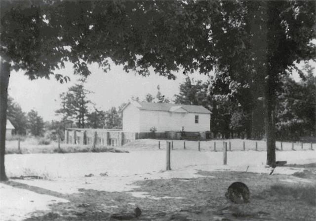 A photograph of the Avondale Methodist Church building before the congregation acquired a new building in 1953, as seen across a field.