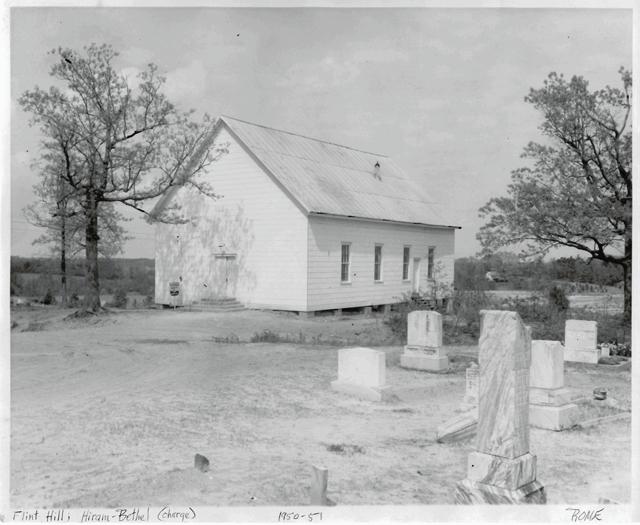 A photograph of the Flint Hill Methodist Church building and cemetery.