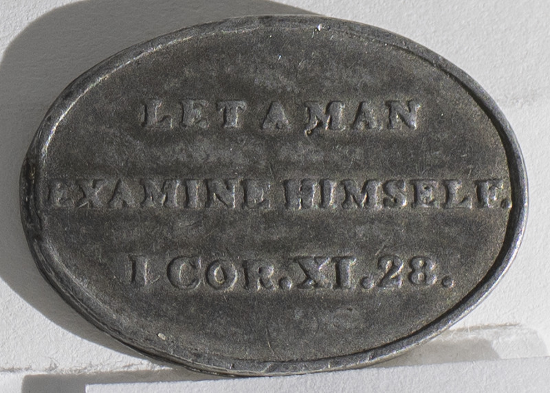 A communion token from the Free Church of Scotland. The token is oval in shape with inscriptions on the obverse, &quot;Free Church of Scotland 1843&quot;, and reverse, &quot;Let a Man Examine Himself I Cor.XI.28&quot;.