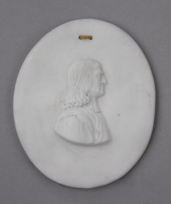 A plaque featuring a portrait of John Wesley in profile.